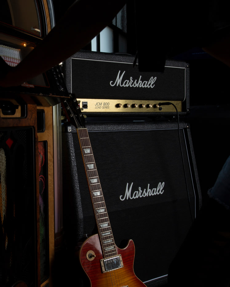 Marshall JCM800 2203 electric guitar and amp in a dark room.