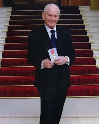 Jim Marshall en la escalinata del Palacio de Buckingham al recibir la Orden del Imperio Británico en 2003.