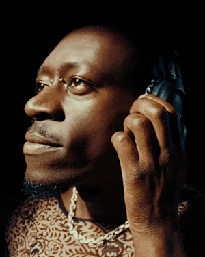 A close up image of a man wearing Marshall Monitor III A.N.C. Black over-ear headphones on.