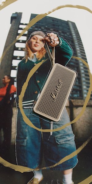 The Marshall Middleton II Cream speaker held by the strap
