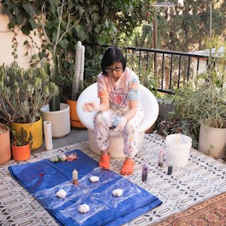 Shirley Kurata creates art on a balcony.