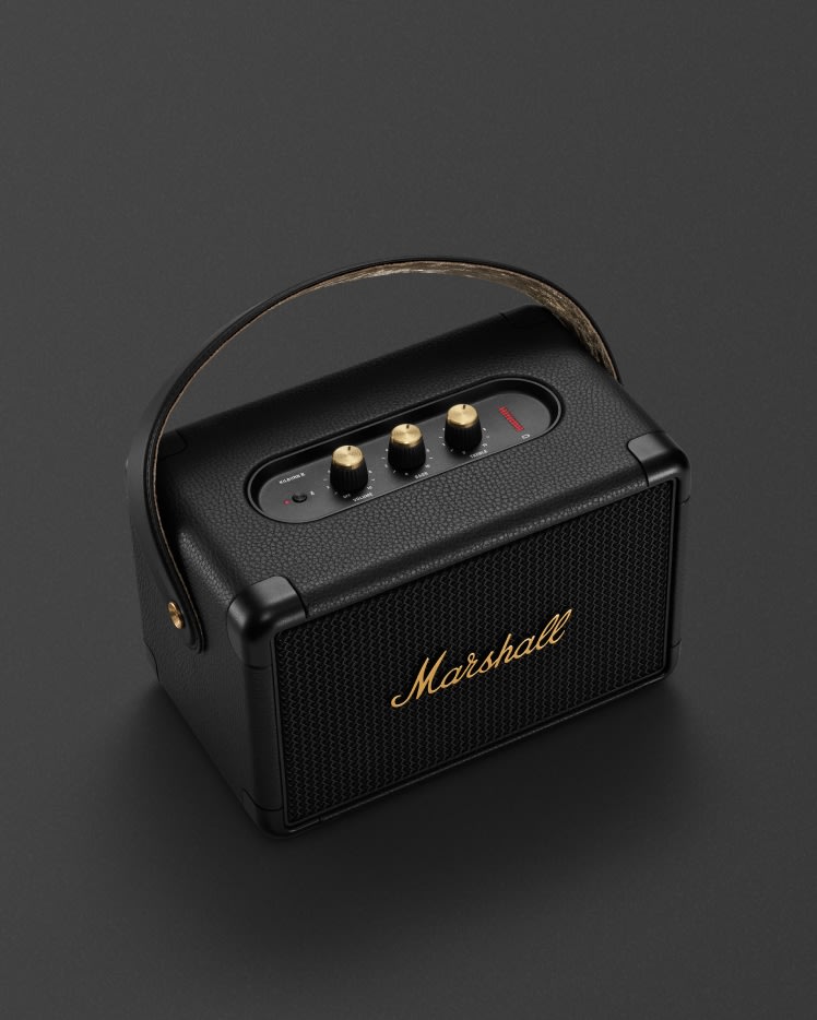 The Marshall KILBURN II BLACK AND BRASS is a portable speaker with Bluetooth capabilities.