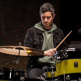 Joe Lazarus playing a drum by Natal