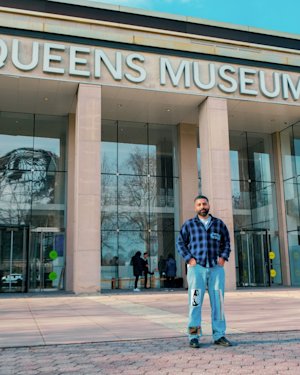 Angelo Baque in front of the Queens museum.