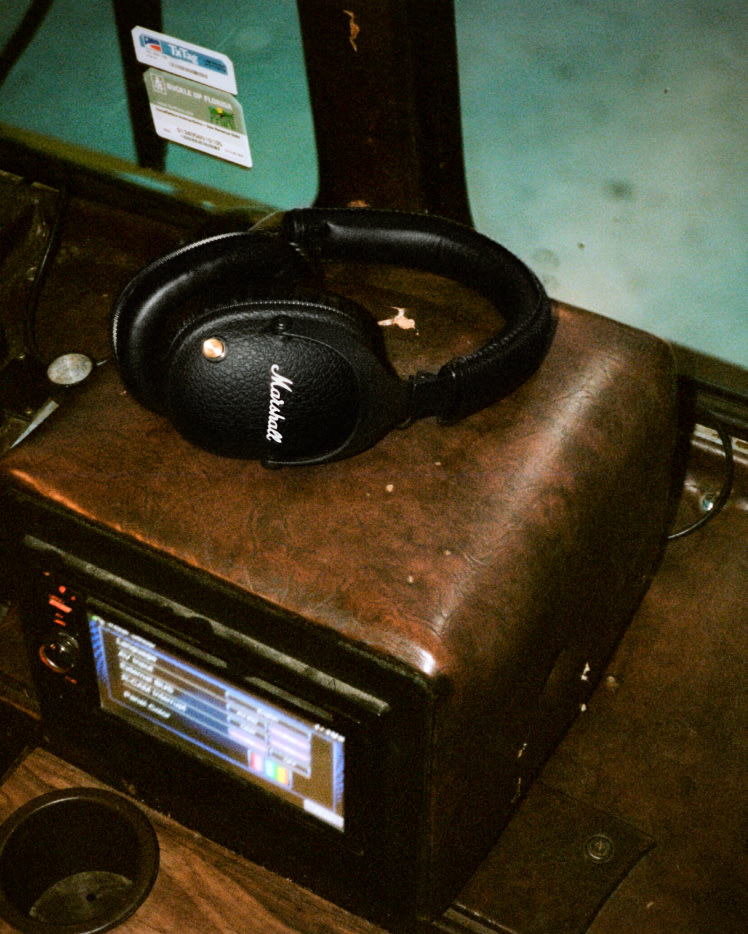 Marshall Monitor II A.N.C. black headphones sitting on top of a radio device.