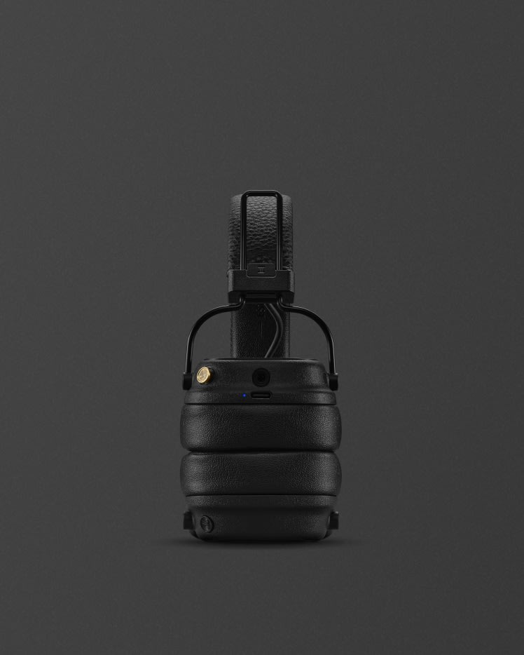 Folded Marshall Major V Black on-ear wireless headphones against a dark background.