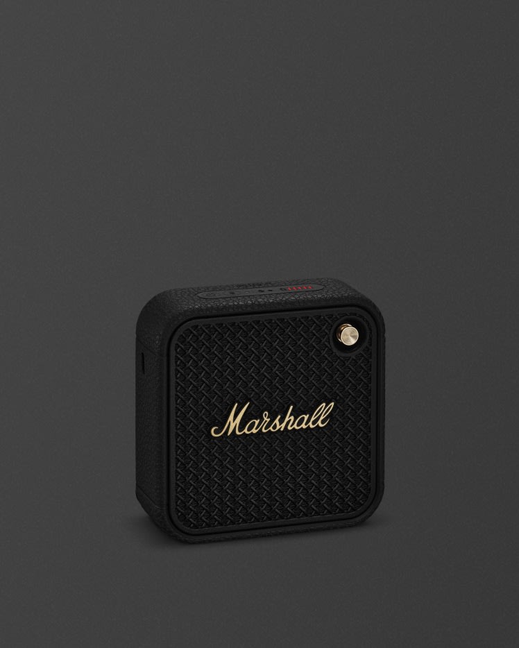 Marshall Willen II Black and Brass portable bluetooth speaker against a dark backround.
