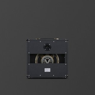 A black Marshall Studio Classic guitar cabinet with an open back reveals a Celestion speaker and internal components, set against a plain dark background.