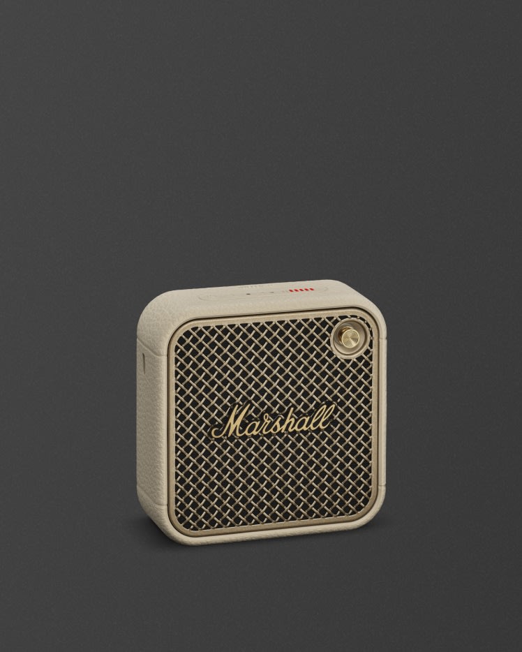Marshall Willen II Cream Bluetooth speaker featuring a gold logo, on a dark background.