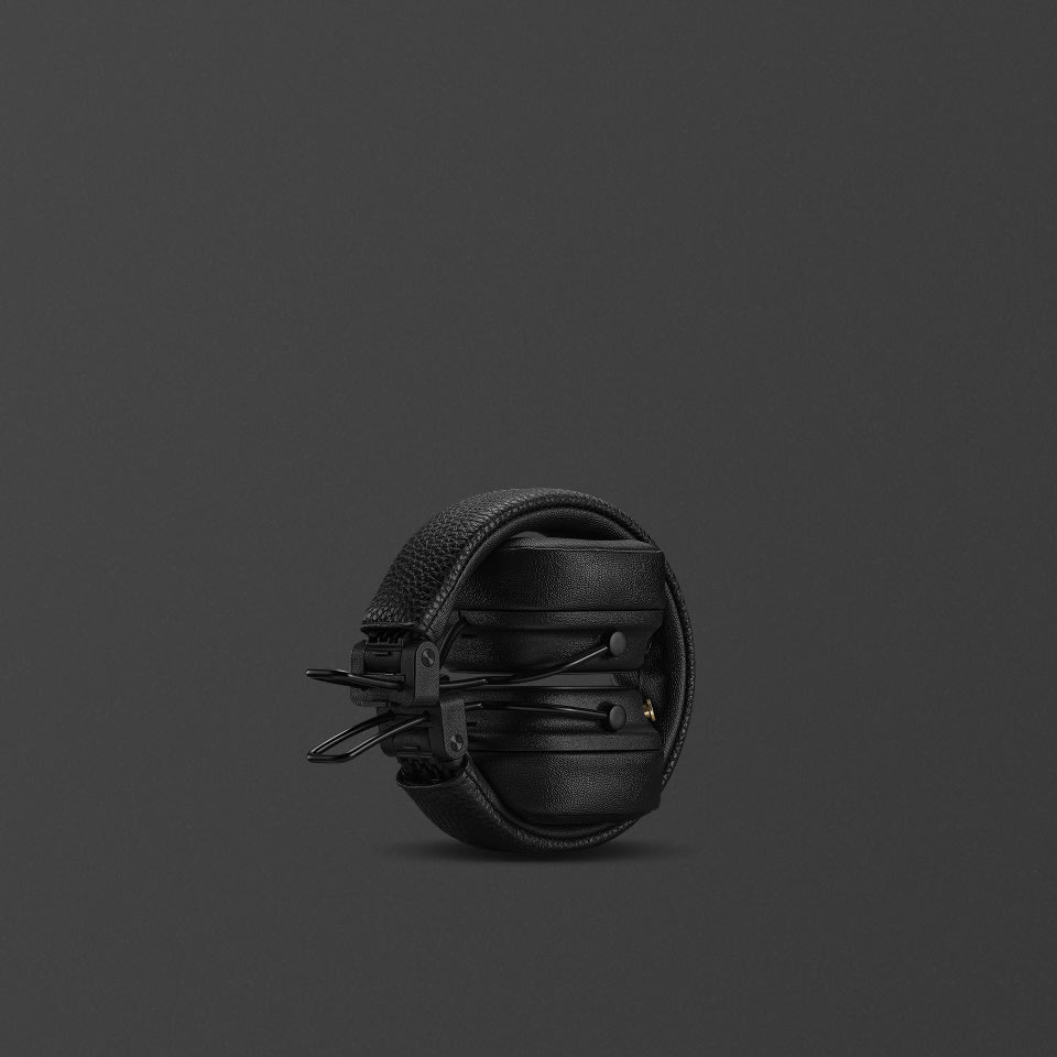 Ein Paar gefaltete, schwarze Major V Over-Ear-Kopfhörer vor einem schlichten, dunklen Hintergrund.