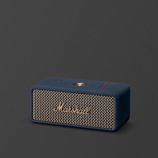 A Marshall Emberton III portable speaker in Midnight Blue with a brass fret and logo, placed on a plain dark background.