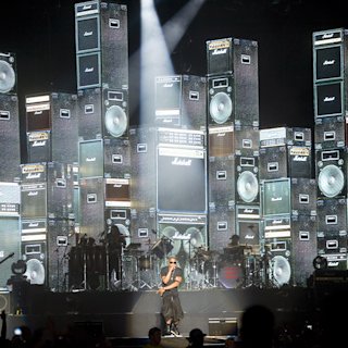 Jay-Z performing on stage surrounded by a screen of different cabs