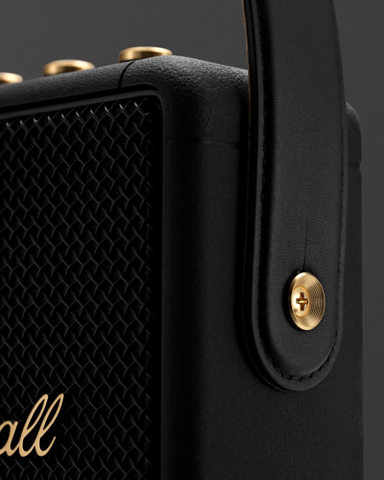 Focus on the strap detail on the side of the Marshall Stockwell II Black and Brass Speaker
