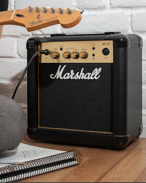 A Marshall MG10 used by a beginner guitarist to play his guitar