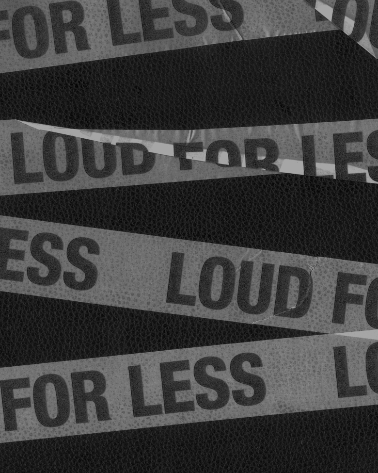 White tapes with the 'Less for loud' words written in it.