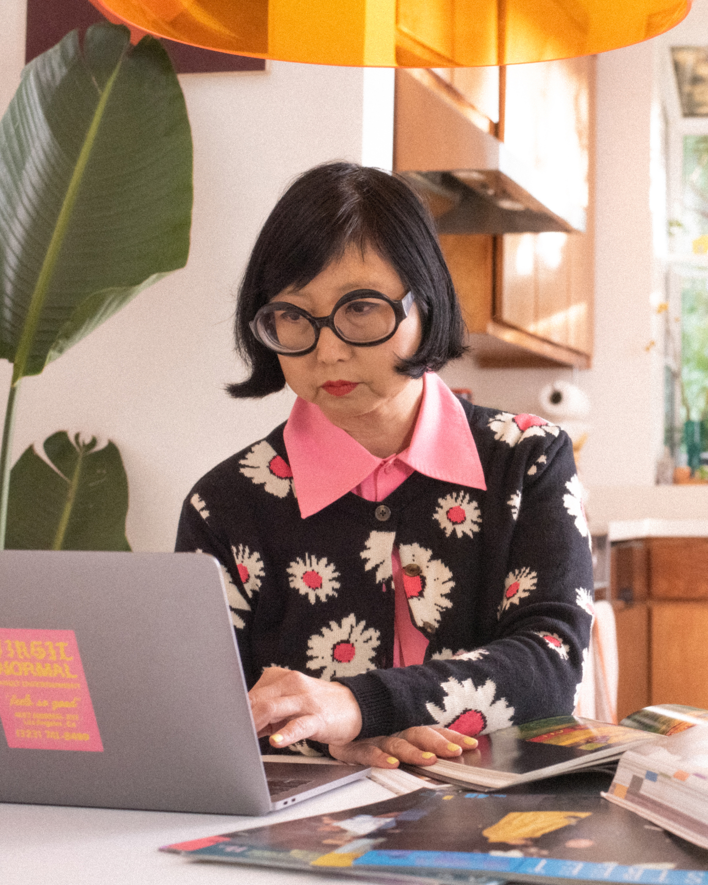 Shirley Kurata sits in front of a computer 