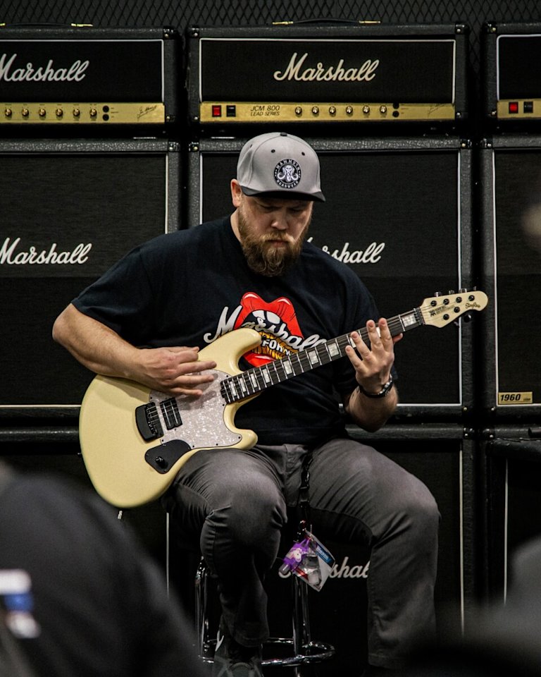 Ryan 'Fluff' Bruce playing guitar at NAMM