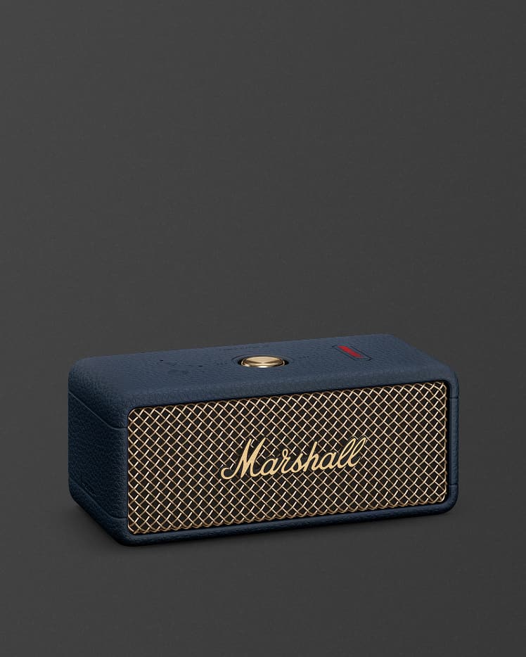 Marshall Emberton III Midnight Blue portable Bluetooth speaker featuring striking gold accents is displayed against a plain dark background.