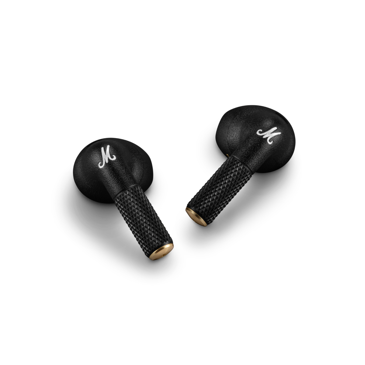 Two black Marshall Minor IV earbuds lying on a dark surface.