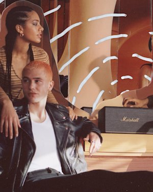 People sitting on a bench with Marshall speakers