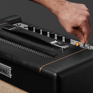 A person is attaching a ST20C knob to a Marshall amplifier.