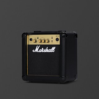 A black and brass Marshall MG10 guitar amplifier combo with control knobs, input jacks, and the brand logo on the front, set against a plain dark background.