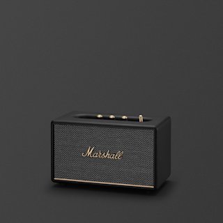 A black Marshall Acton III Bluetooth home speaker with brass accents and control knobs is placed against a plain dark background.