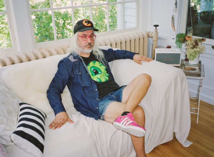 J Mascis sitting on a couch.