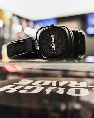 The Marshall Major V black headphones placed near a table by Rough Trade.
