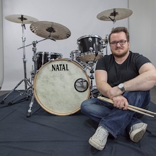 Nick Poyner siting next to a Natal drum