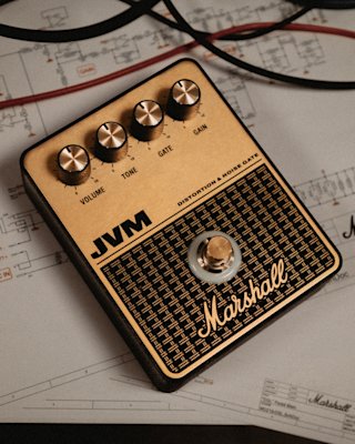 The Marshall JVM Overdrive pedal in front of sound test results.