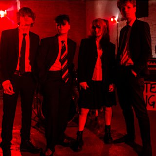 Artist 'Noah and the Loners' under a red spotlight.