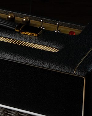 Focus on the control knobs and logo of the Marshall Black and Gold Handwired Amplifier.