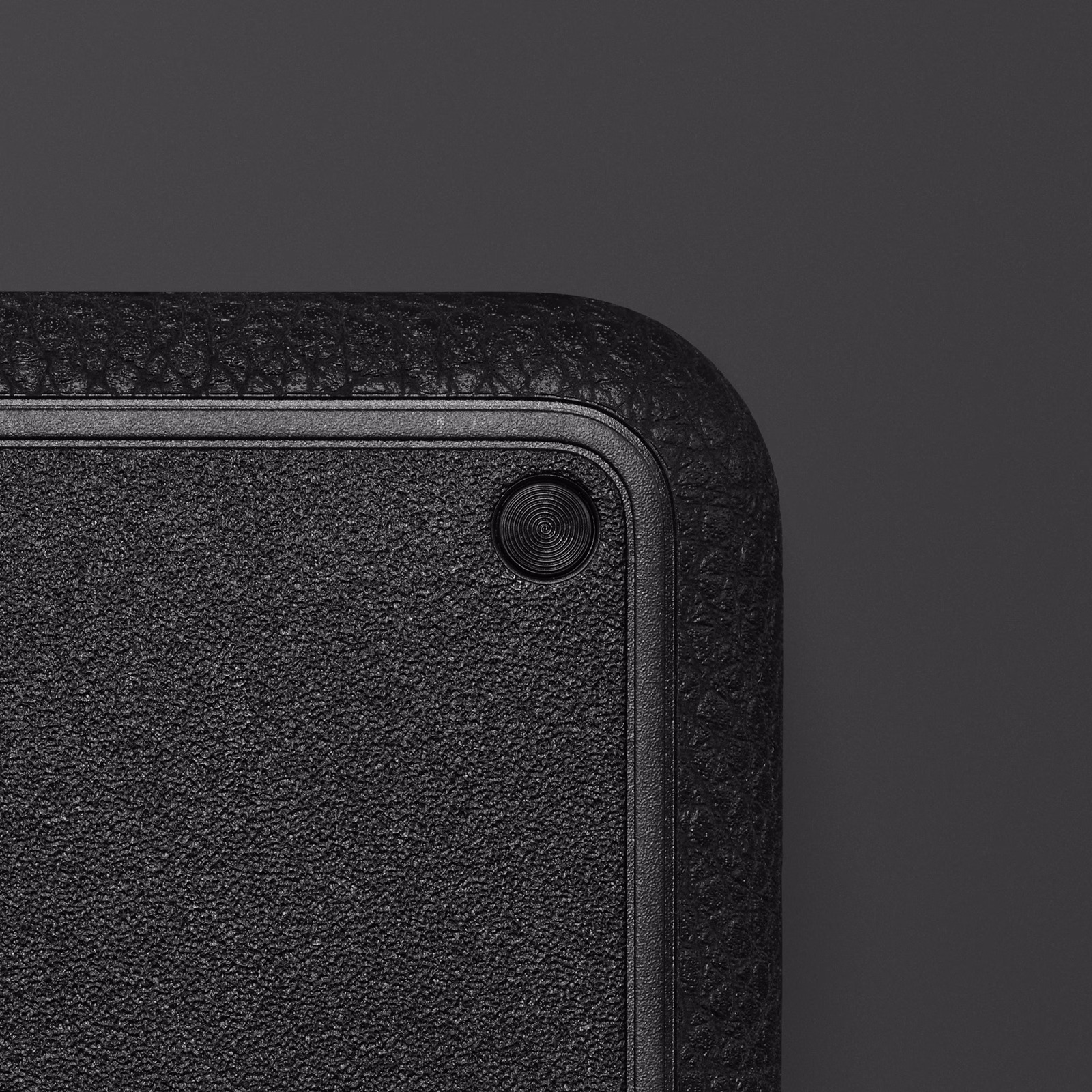 Close-up of the textured corner of a Heddon set against a dark background.