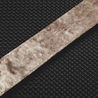 A Marshall Stockwell II portable speaker on a black surface with a brown belt.