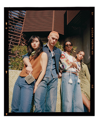 Un grupo de personas posa para una foto con un altavoz portátil Marshall WILLEN.