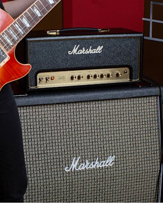 The Marshall Origin20 Head amplifier connected to a red guitar and to a Marshall Cabinet