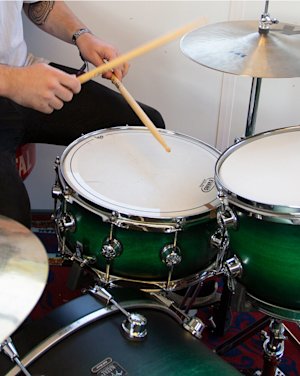Person playing green Natal snare drums