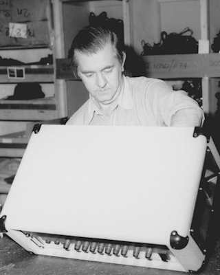 An old photo of a man working on a Marshall Studio Jubilee Head amplifier.