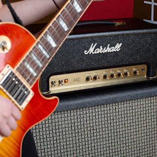 A guitarist playing connected to the Origin20 Head by Marshall amplifications