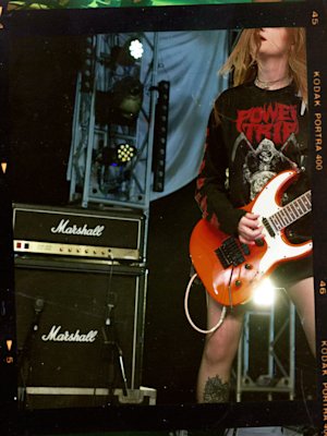 A man playing a Marshall JCM800 2203 electric guitar at a concert.