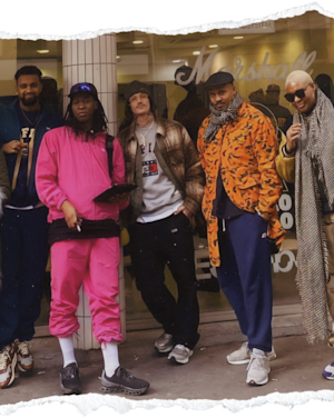 Group of five individuals posing confidently in urban streetwear with a Marshall Patta portable speaker.