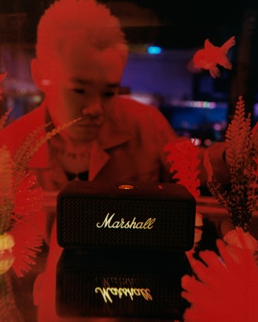 Bohan Phoenix holding Marshall Emberton III Black and Brass portable speaker.