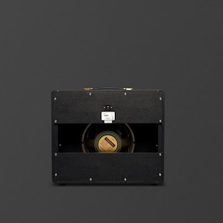 A black Marshall 1974CX guitar amplifier is shown from the back, revealing the speaker and internal components against a plain dark background.