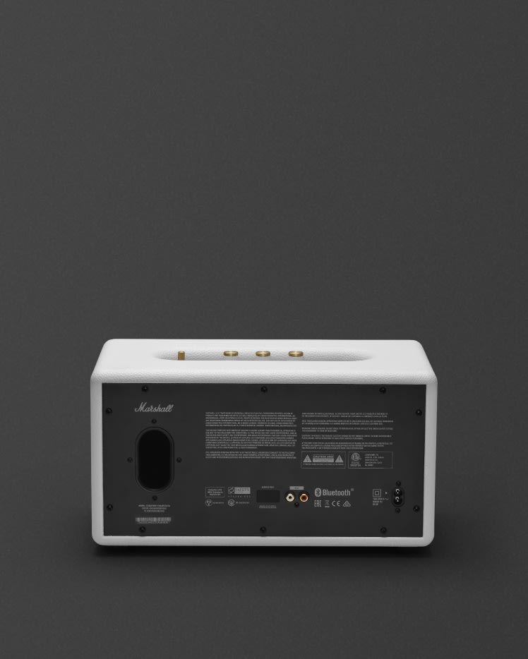 The front of a Marshall Stanmore II Bluetooth White speaker on a grey background.