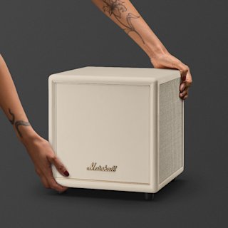 A Marshall Heston Sub 200 subwoofer in cream with a metallic back panel, featuring the Marshall logo, input ports, a power switch, and a power socket, against a plain dark background.