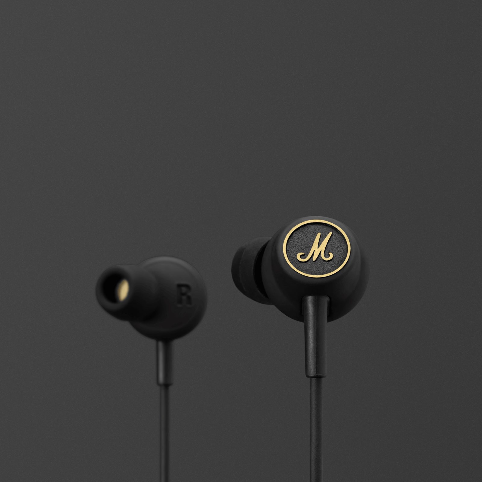 A pair of black Marshall Mode EQ earphones with a gold logo.