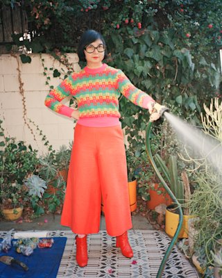 Shirley Kurata standing on a balcony.