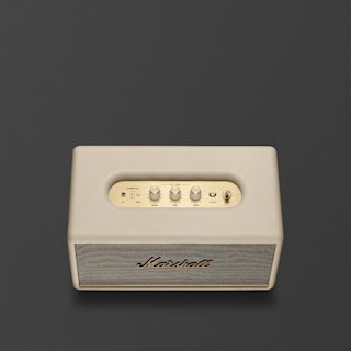 A Marshall Stanmore III Bluetooth home speaker in cream with brass accents and control knobs is shown against a plain dark gray background.