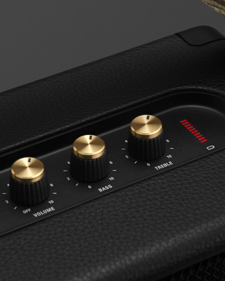 A close up of a Marshall KILBURN II BLACK AND BRASS speaker with gold knobs.